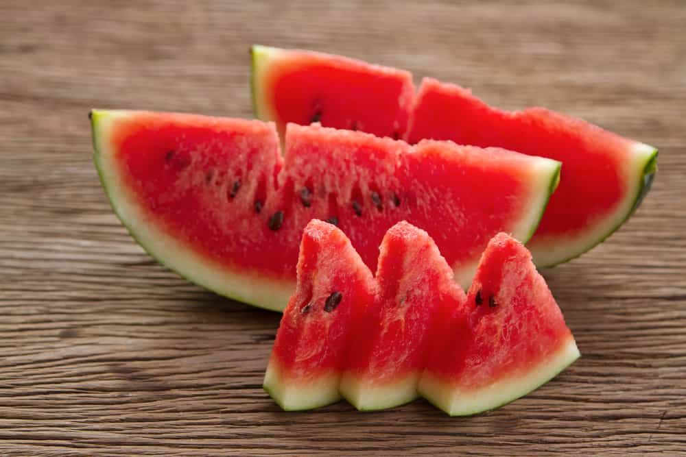 watermelon slices on wooden table